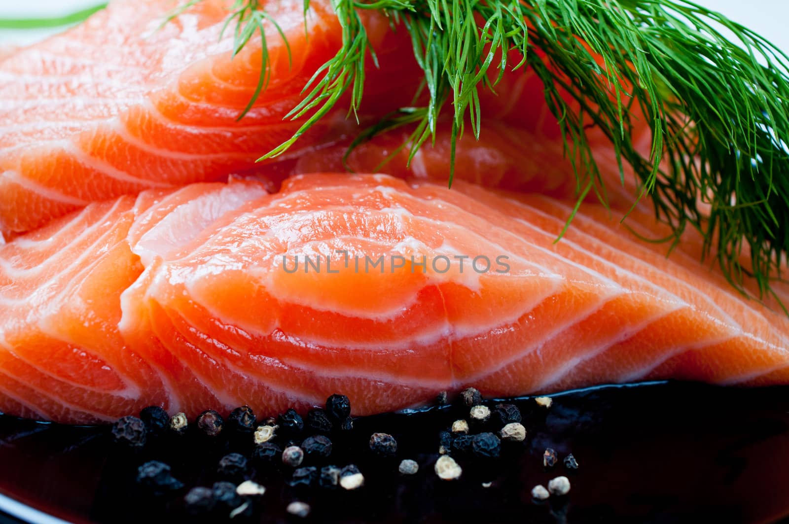 Salmon with black pepper and dill close up