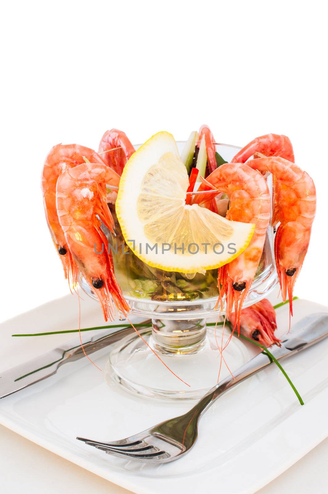 Shrimp cocktail with lemon on glass bowl close up