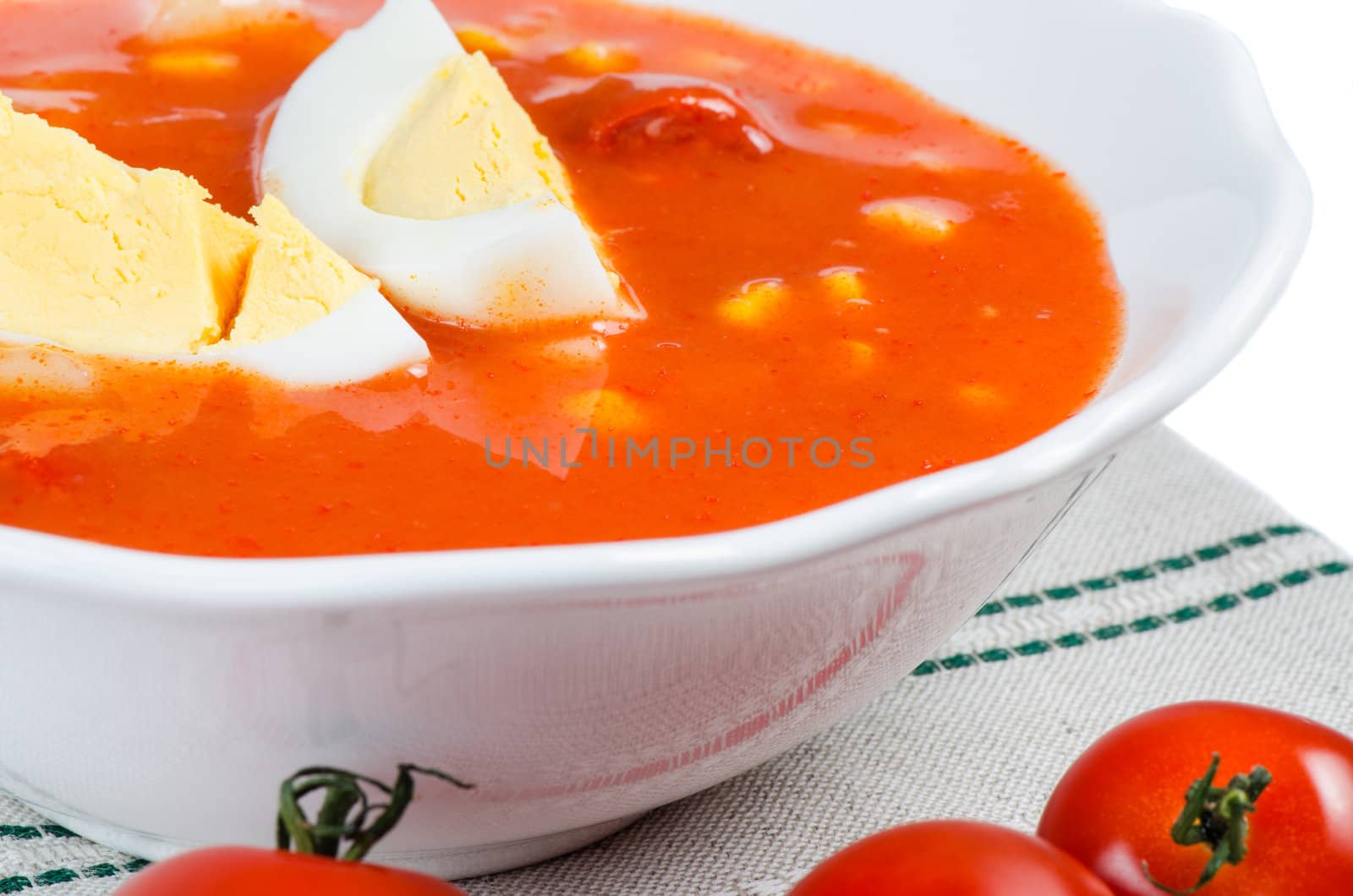 Tomato soup with eggs in white bowl