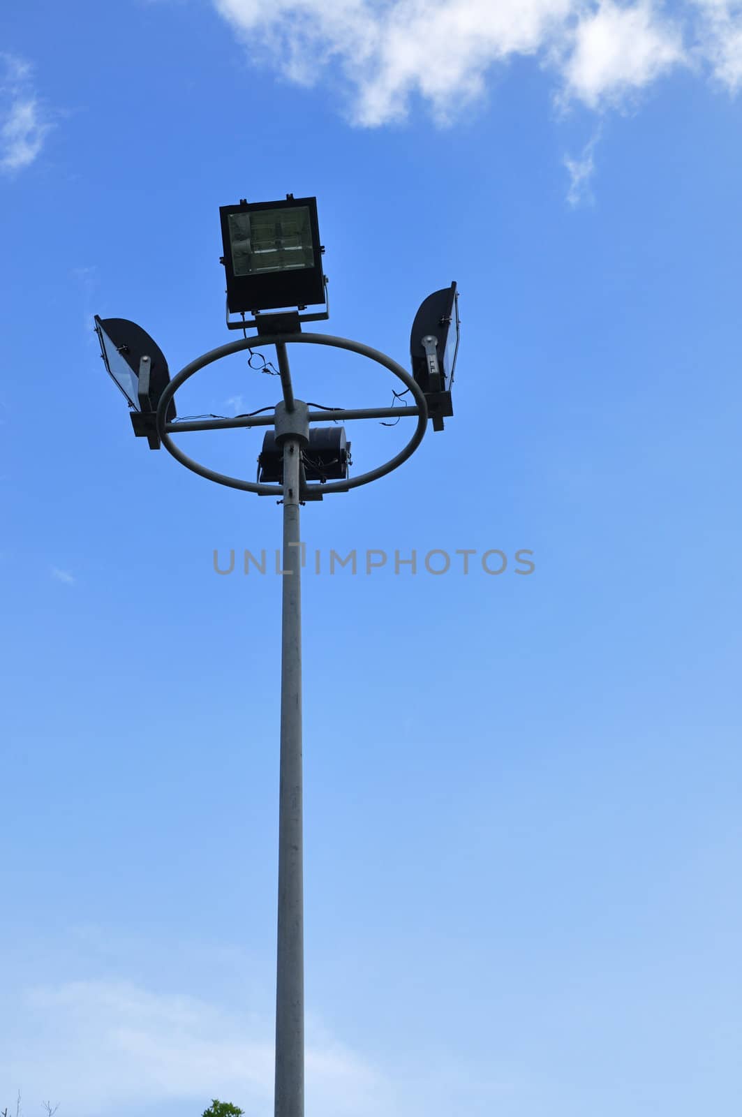 Spotlight steel poles in stadium and blue sky