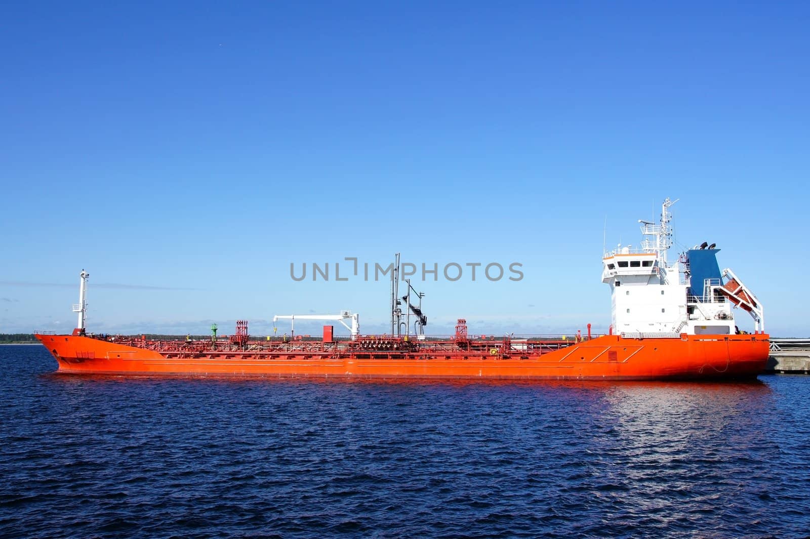 The tanker is moored in the port and loaded fuel