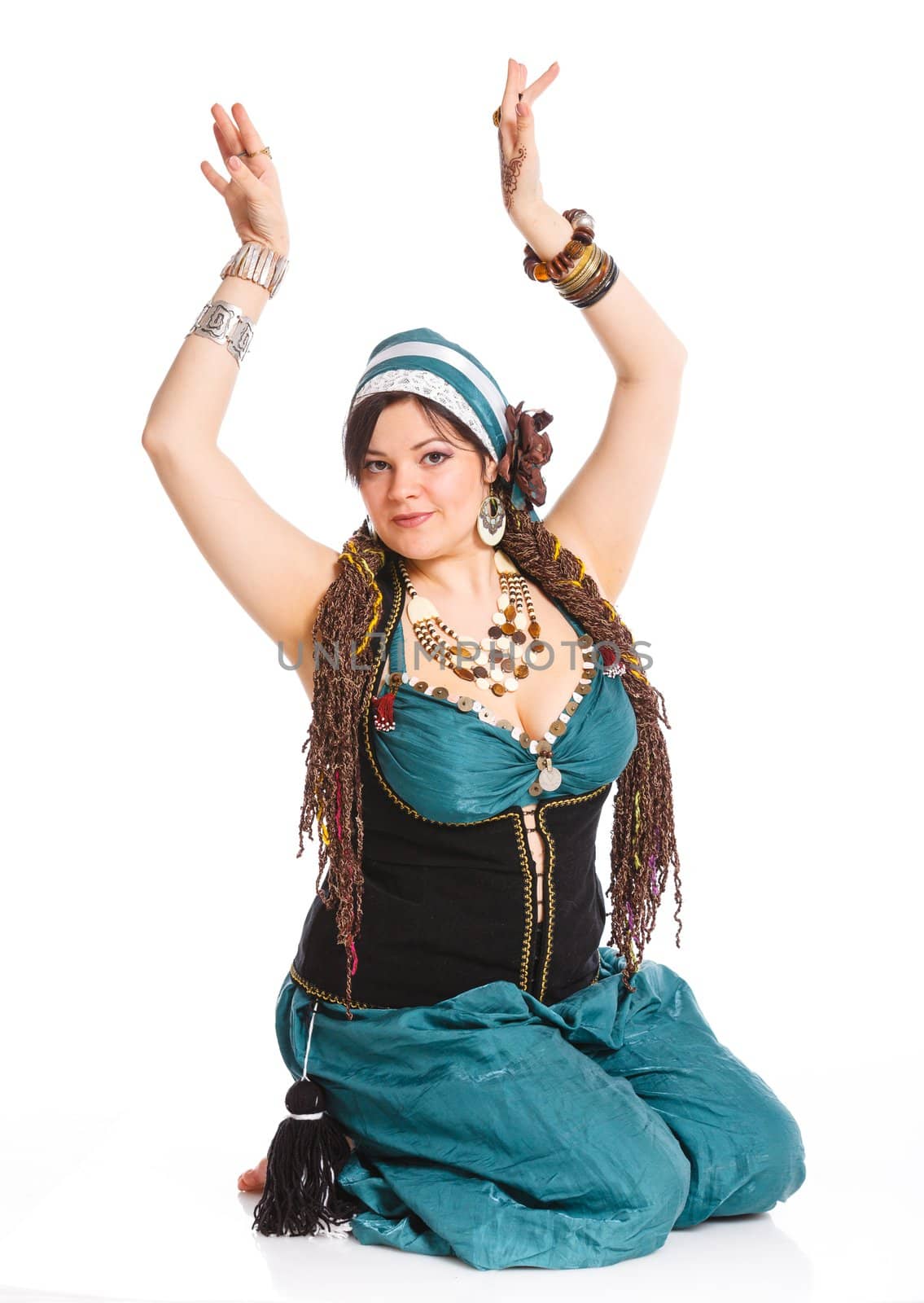 Oriental dancer in blue costume over white background