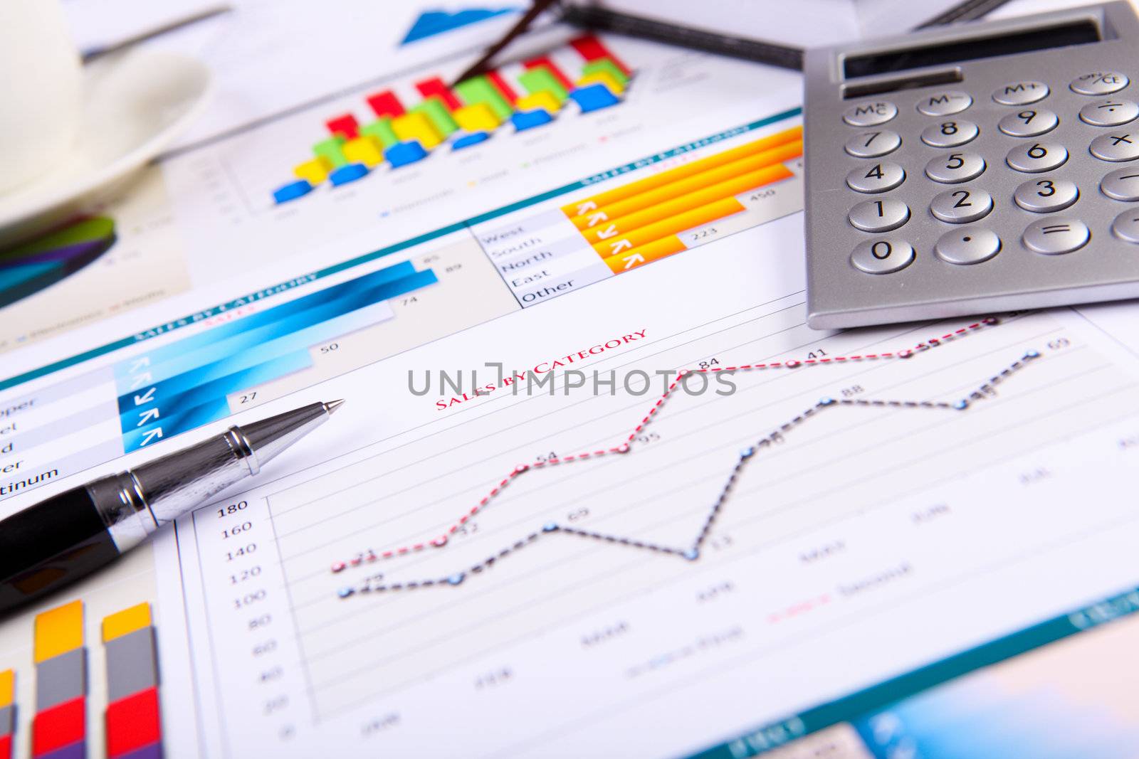 Financial paper charts and graphs on the table