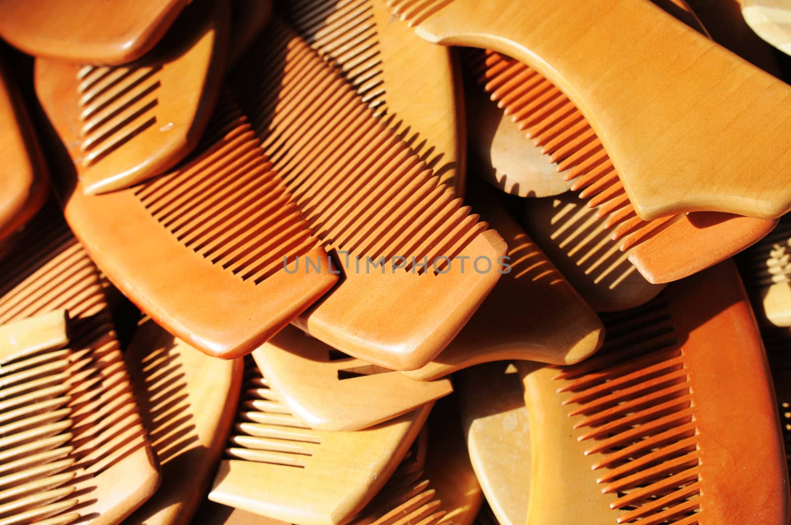 Wooden combs for sale in the sunlight at a market