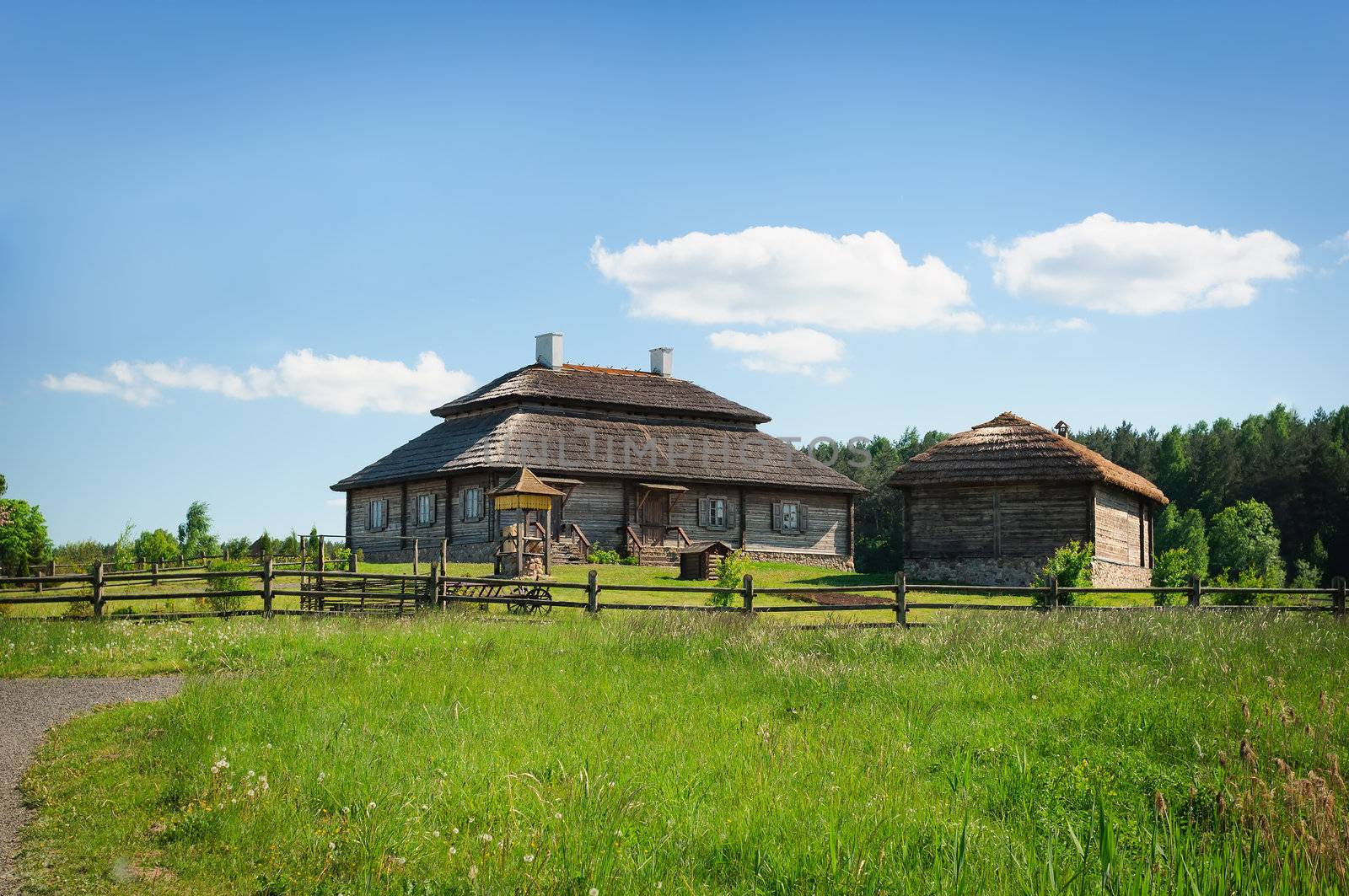 Beautiful landscape with restored old style russian farmhouse with thatch roof 