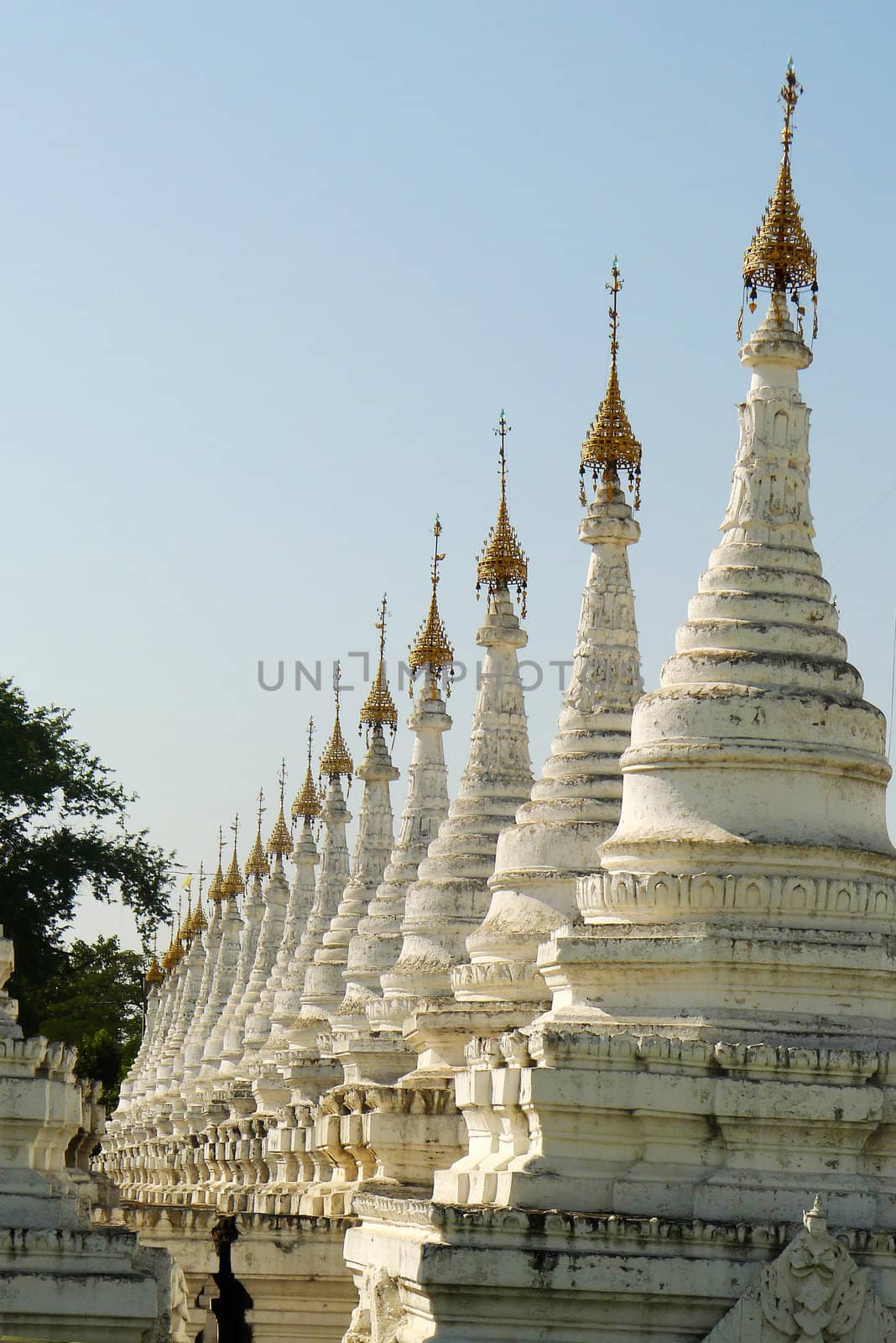Row of historic white buddhist stupa in Myanmar