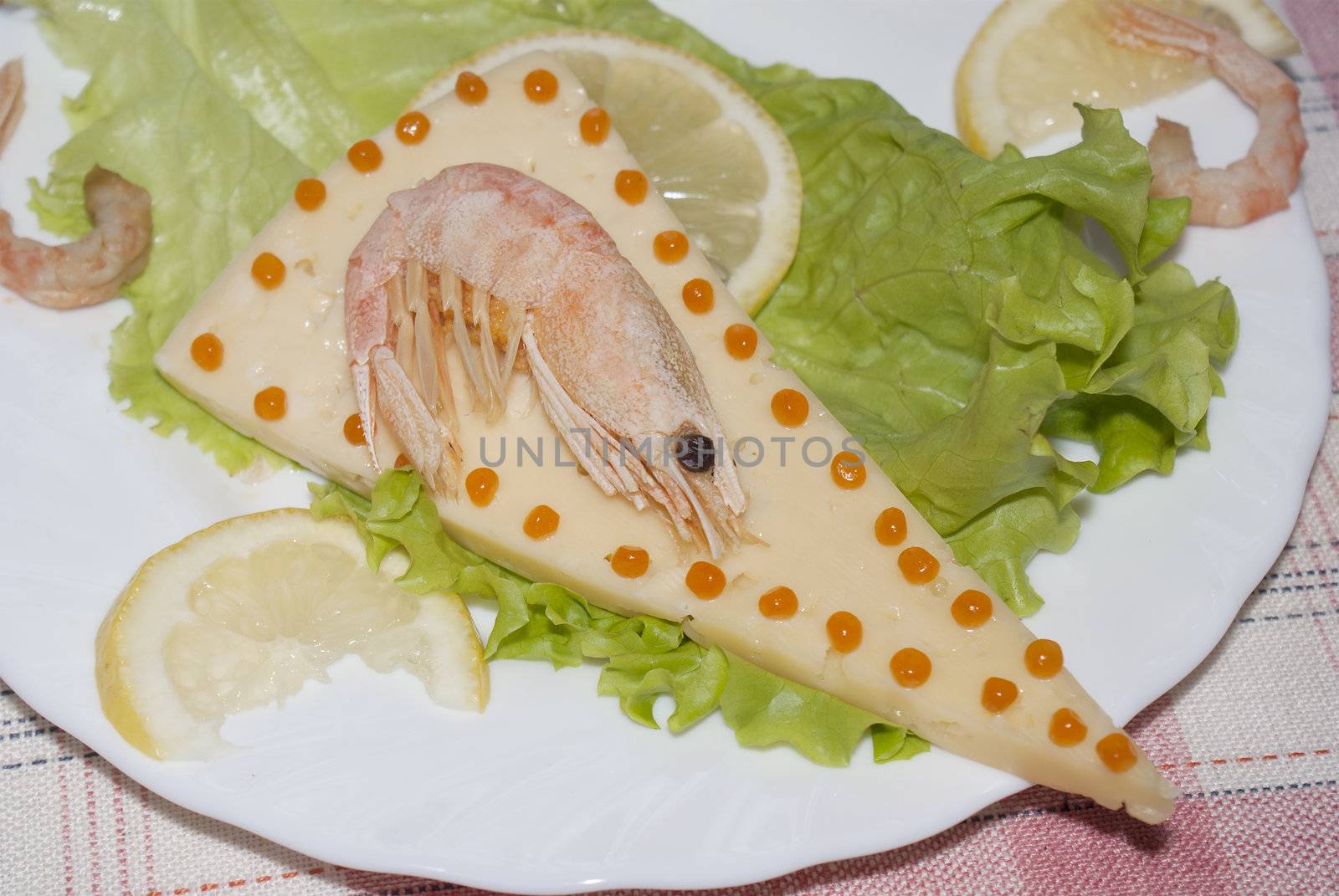 Sea shrimp on cheese with red caviar of a salmon and leaves of green salad .Restaurant background