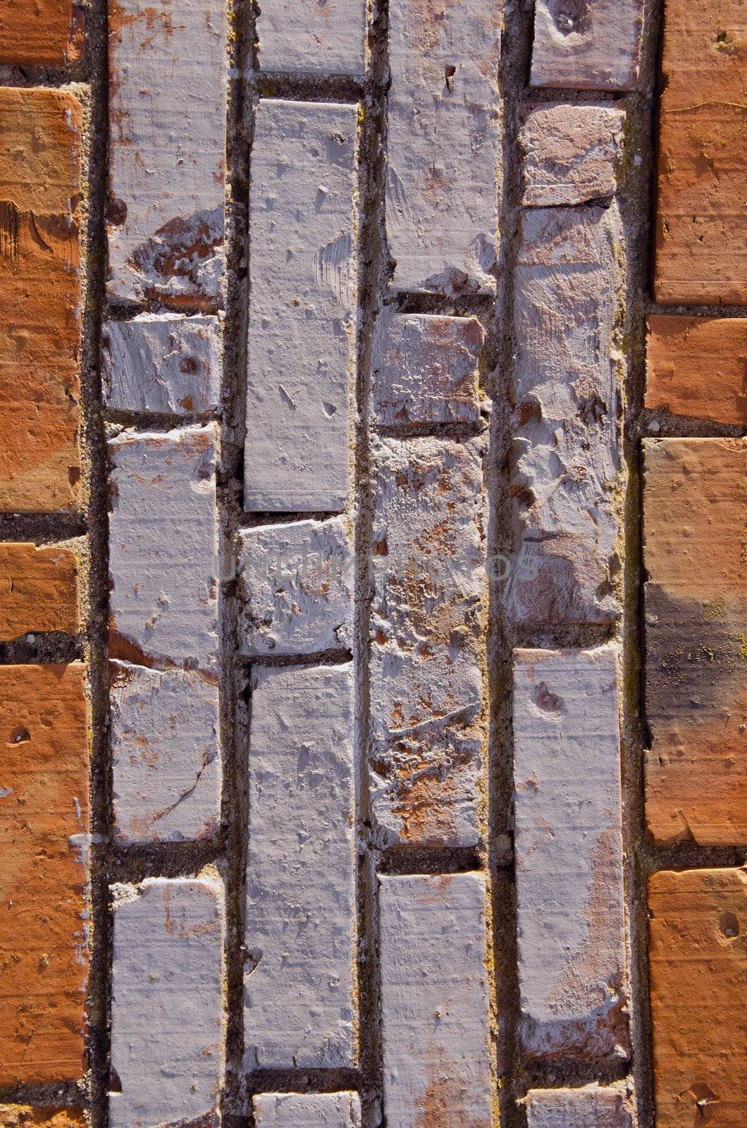 Wall made of red and colored bricks. Architectural decision.