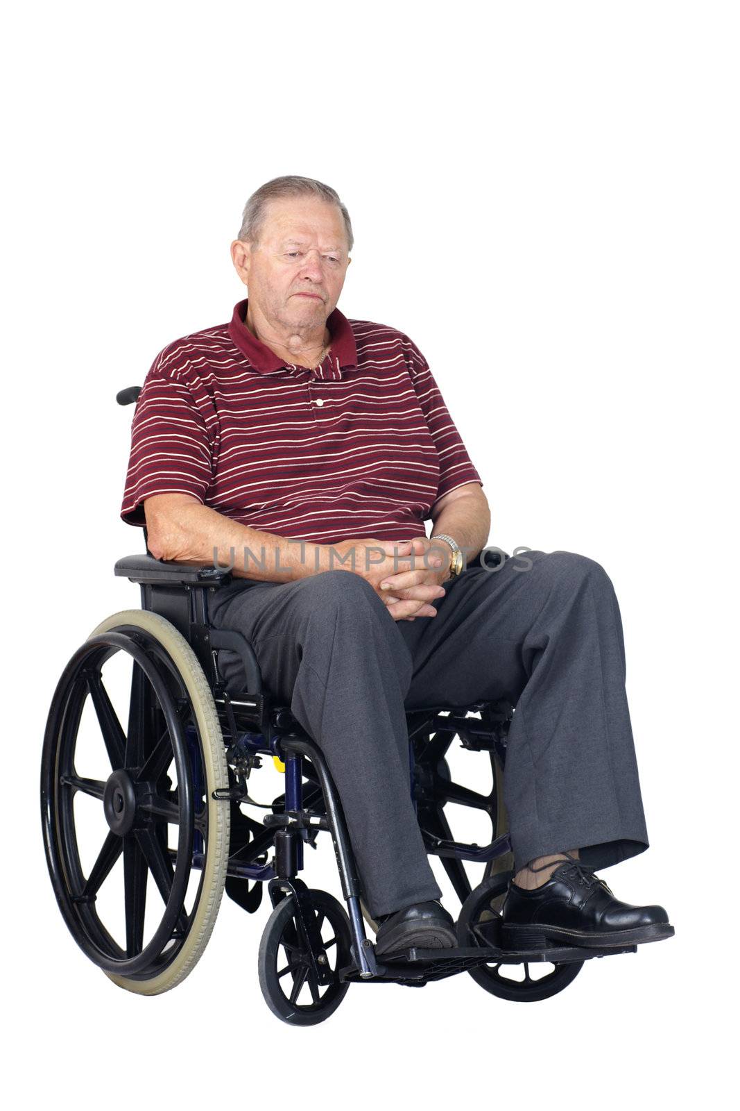 Sad or depressed senior man in a wheelchair, looking down, studio shot isolated over white background.