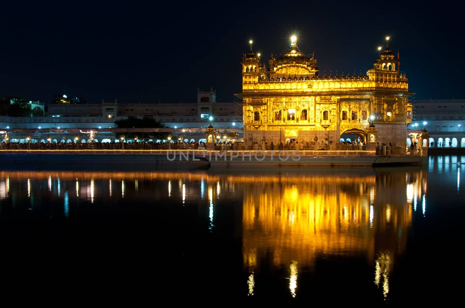 Sikh Golden temple Harmandir Sahib in Amritsar at night, Punjab, India .