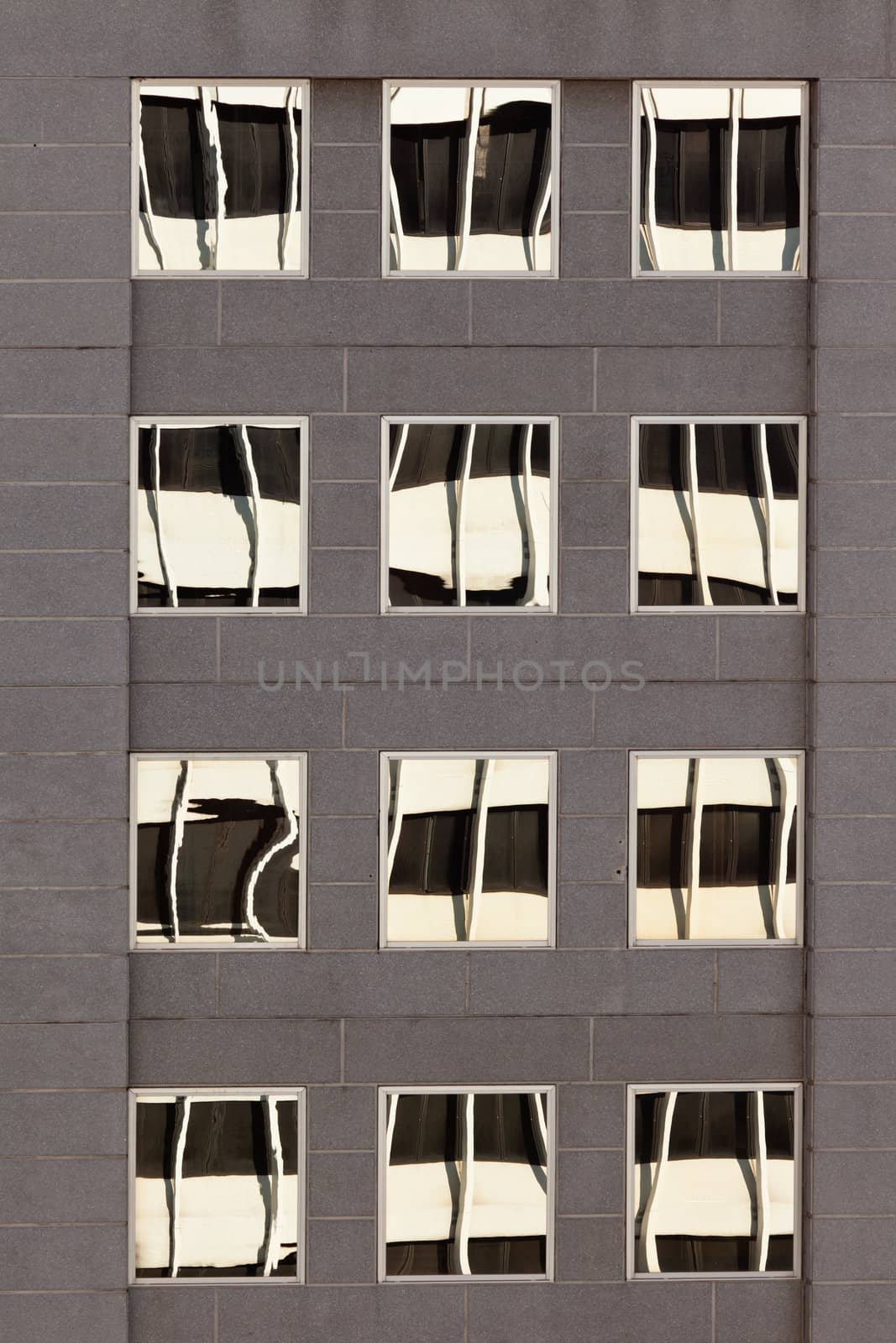 Facade with reflections of building on windows by PiLens