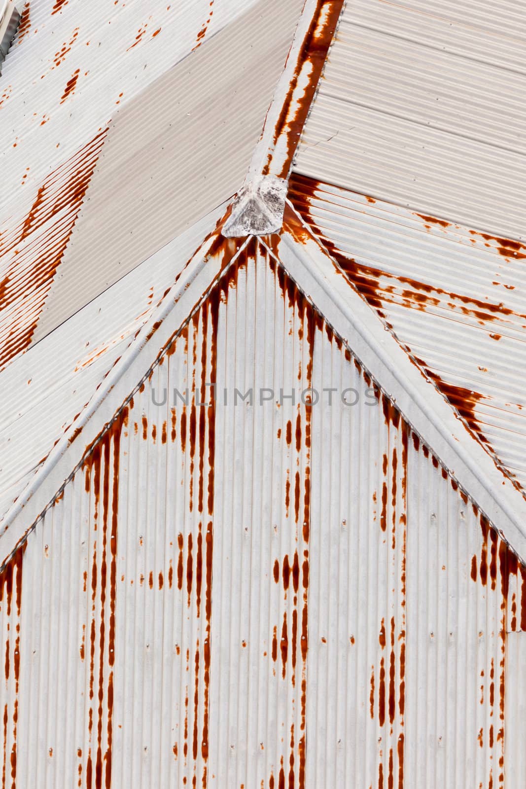 Abstract background texturte pattern of grungy rusting metal roof and galvanised metal clad building