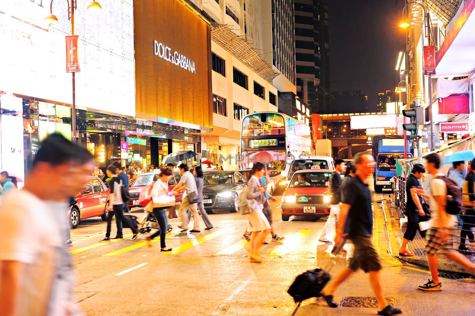 Hong Kong - May 19, 2012: Crowded Hong Kong street. With a land mass of 1,104 km and population of 7 million people, Hong Kong is one of the most densely populated areas in the world