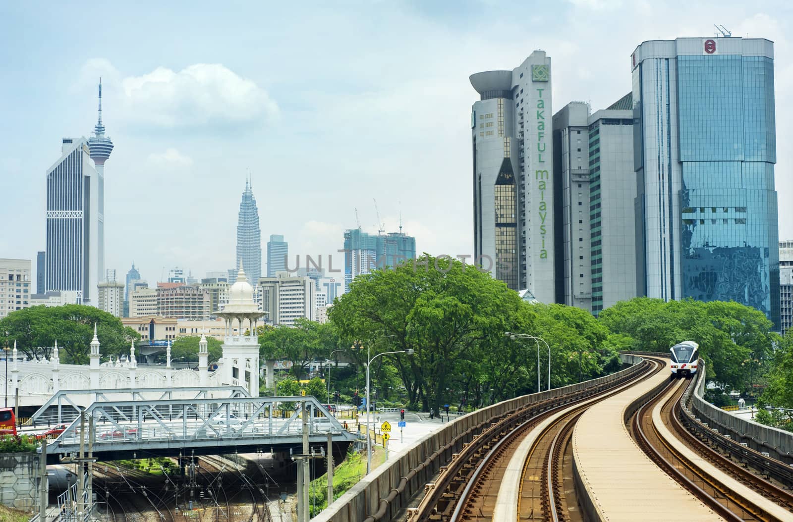 Kuala Lumpur, Malaysia - March 20, 2012: LRT train arrives at a train station in Kuala Lumpur. Kuala Lumpur metro consists of 6 metro lines operated by 4 operators. 