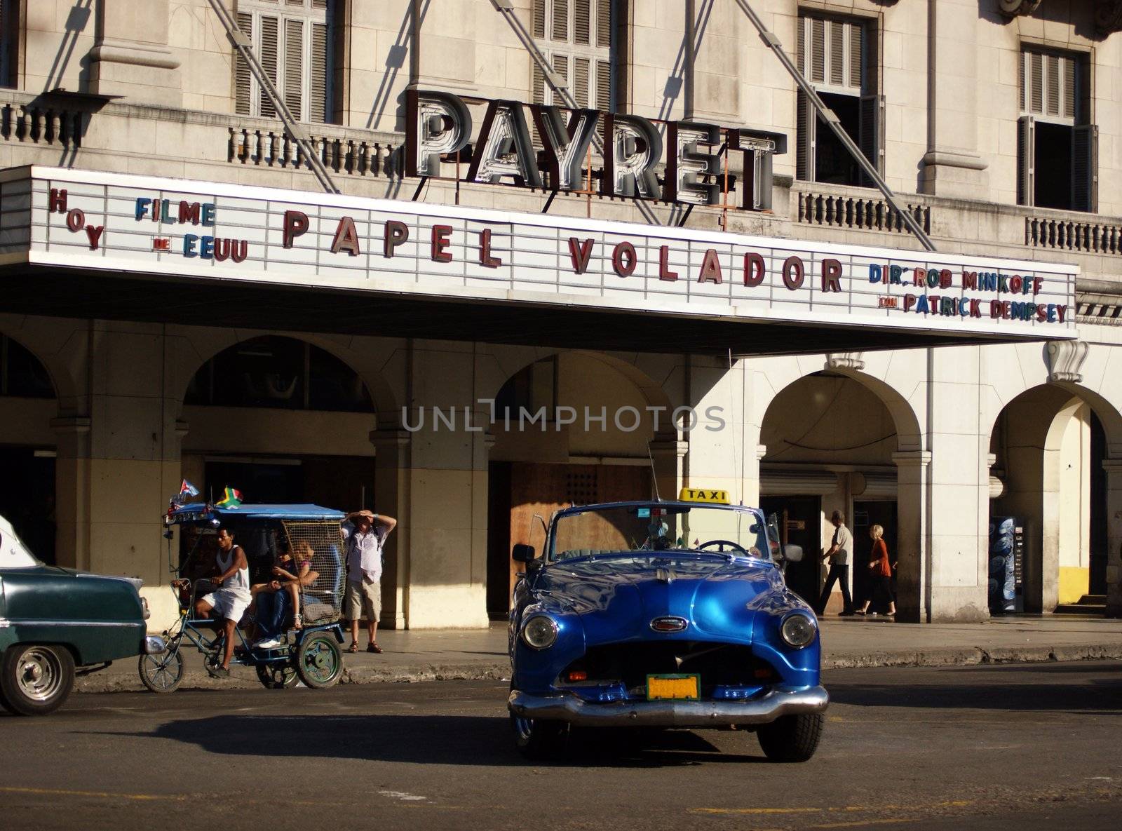 An old American car parked in front of Payret cinema in Havana