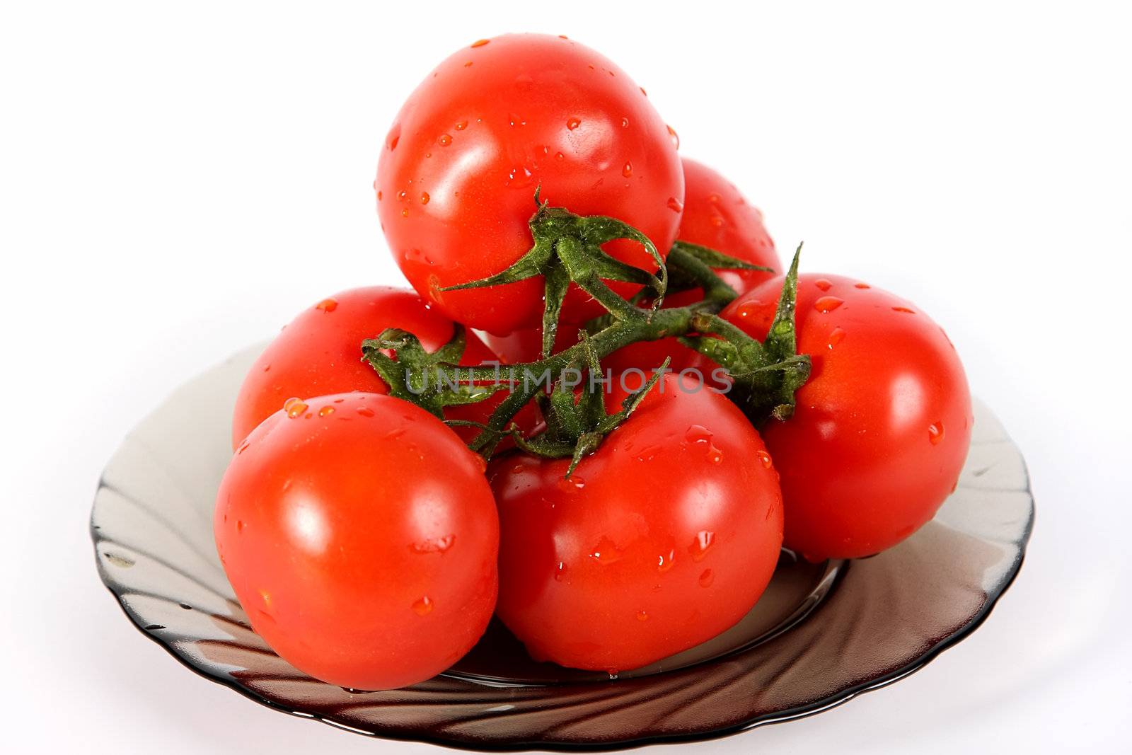 Tomatoes on a plate on a white background