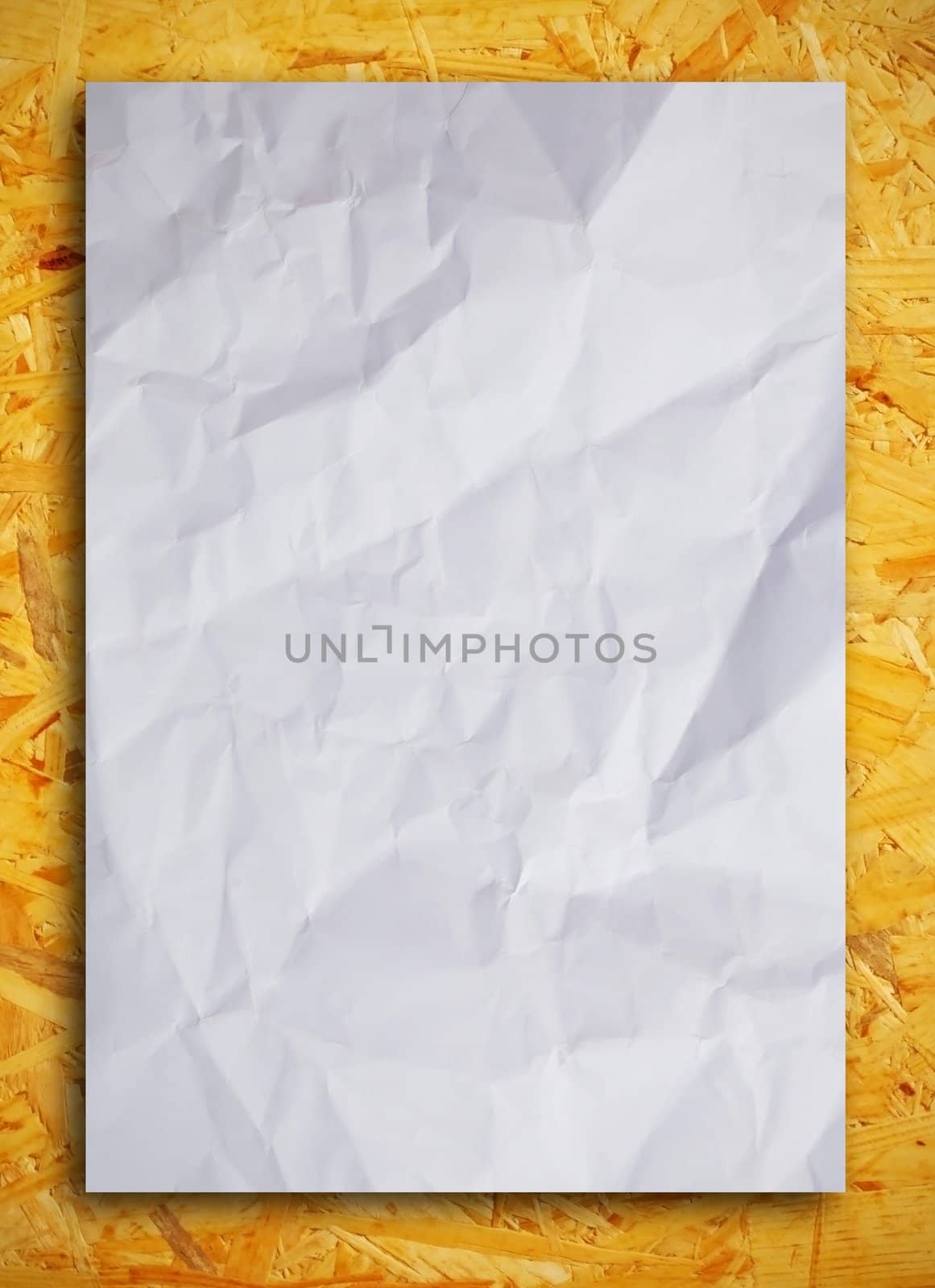 Crumpled paper on wood background