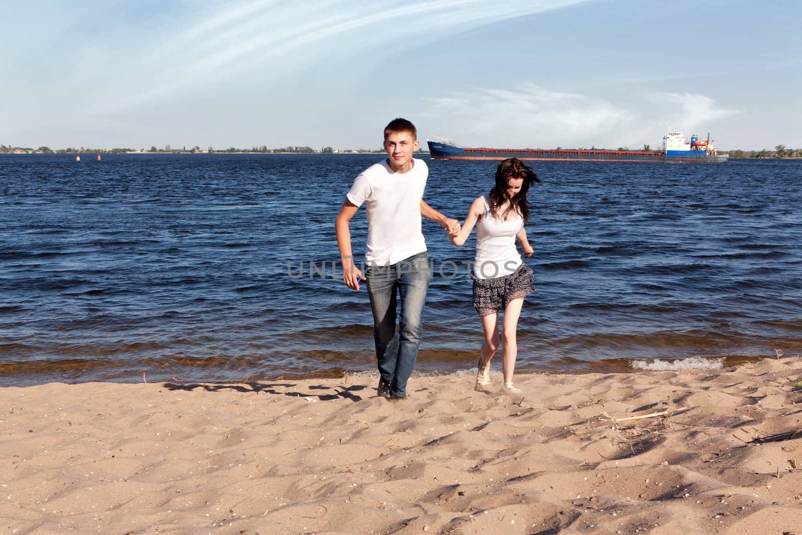 Loving couple running on beach by nigerfoxy