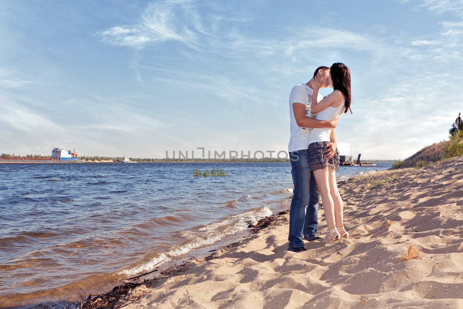 couple kissing on beach by nigerfoxy