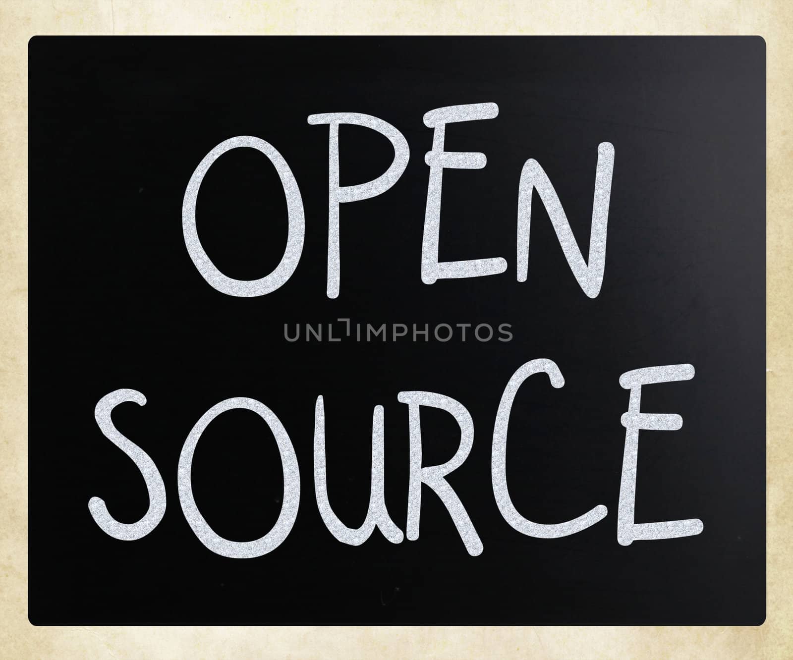 "Open source" handwritten with white chalk on a blackboard.