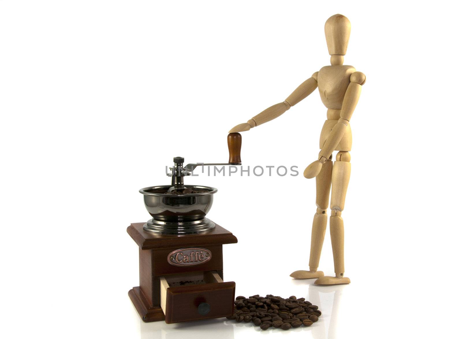 wooden puppet grind coffee on a old machine by compuinfoto
