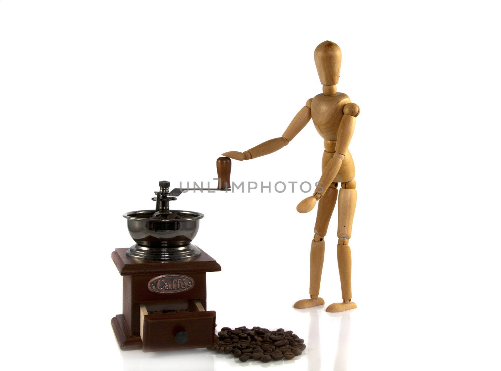 wooden man grind coffee on a old machine by compuinfoto