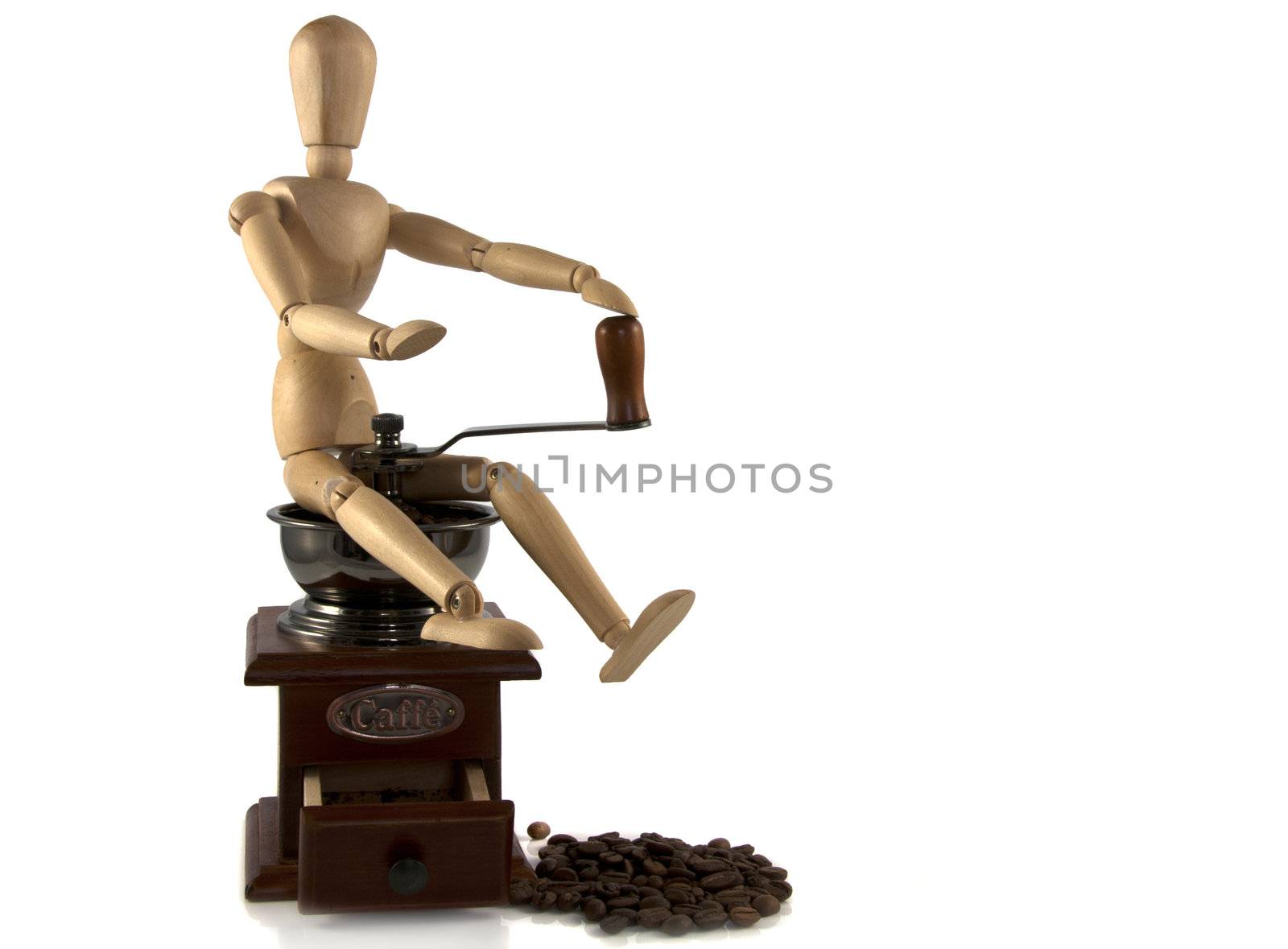 wooden puppet sitting on coffee machine by compuinfoto