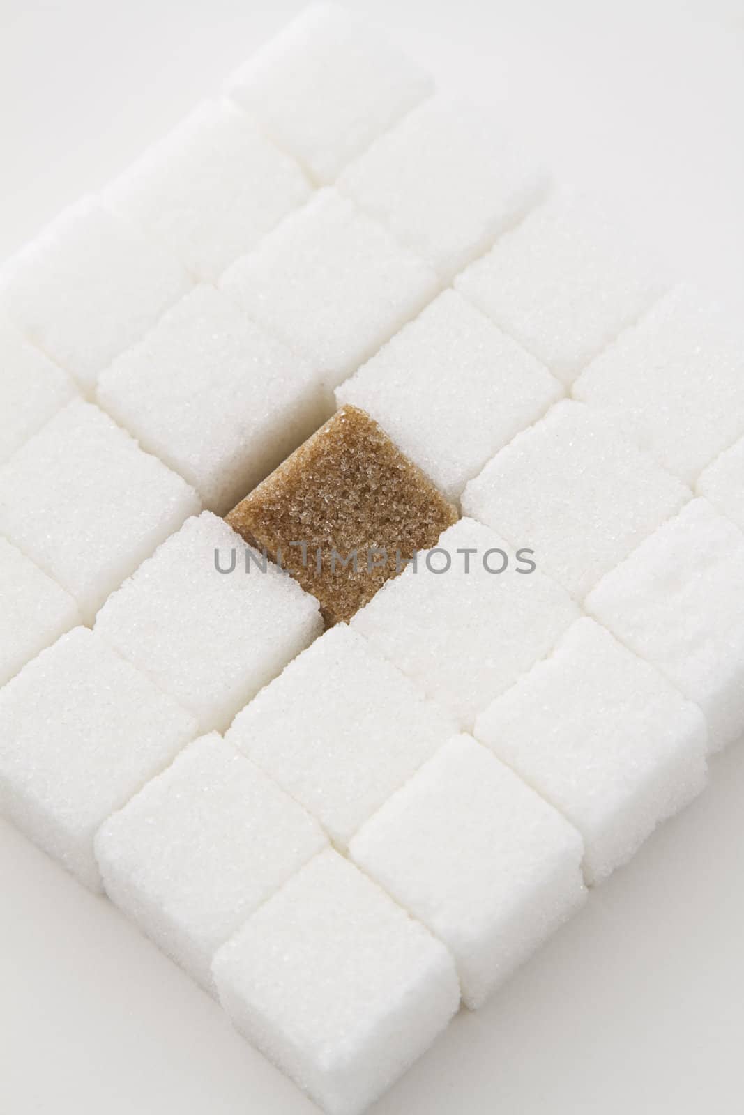 white sugar cube with one brown sugar cube place in a square shape