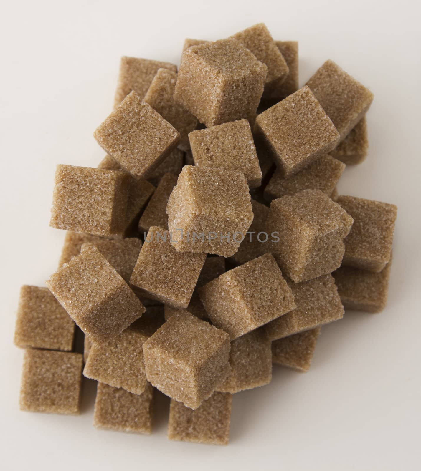 cubes of brown sugar stack in random fashion