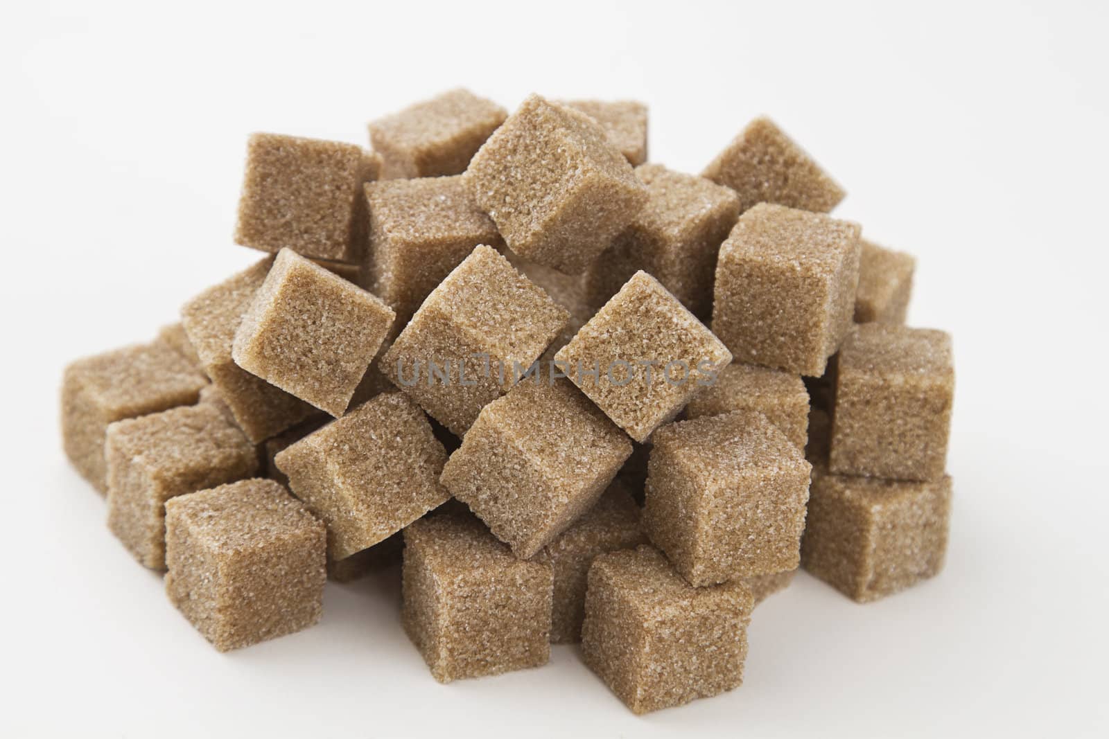 cubes of brown sugar stack in random fashion