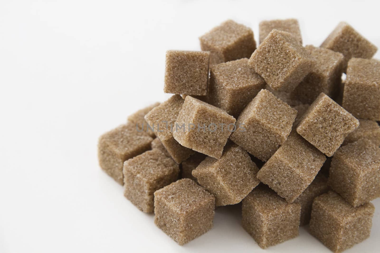 cubes of brown sugar stack in random fashion