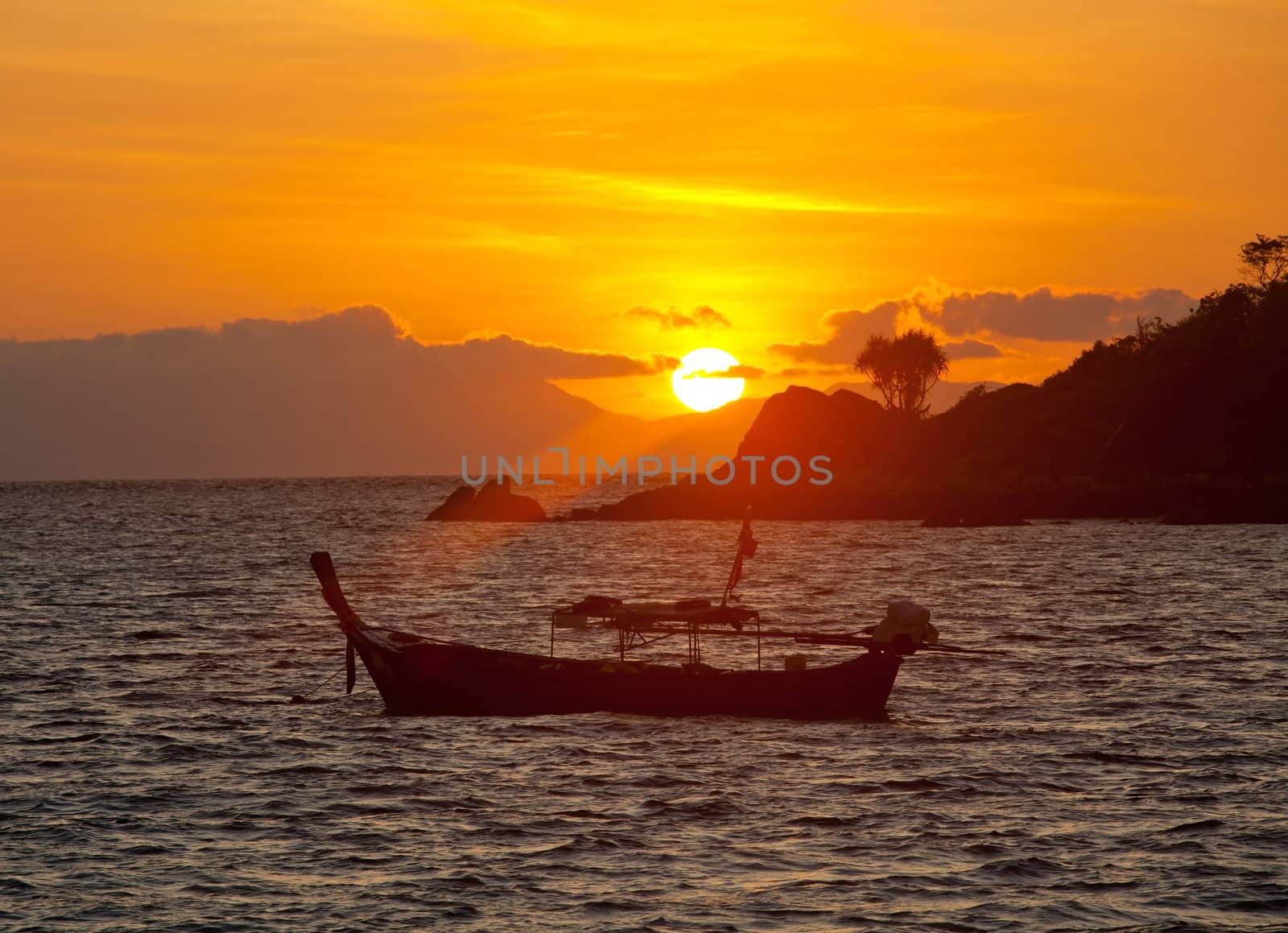 Sunset with boat in Andaman sea , South of Thailand.