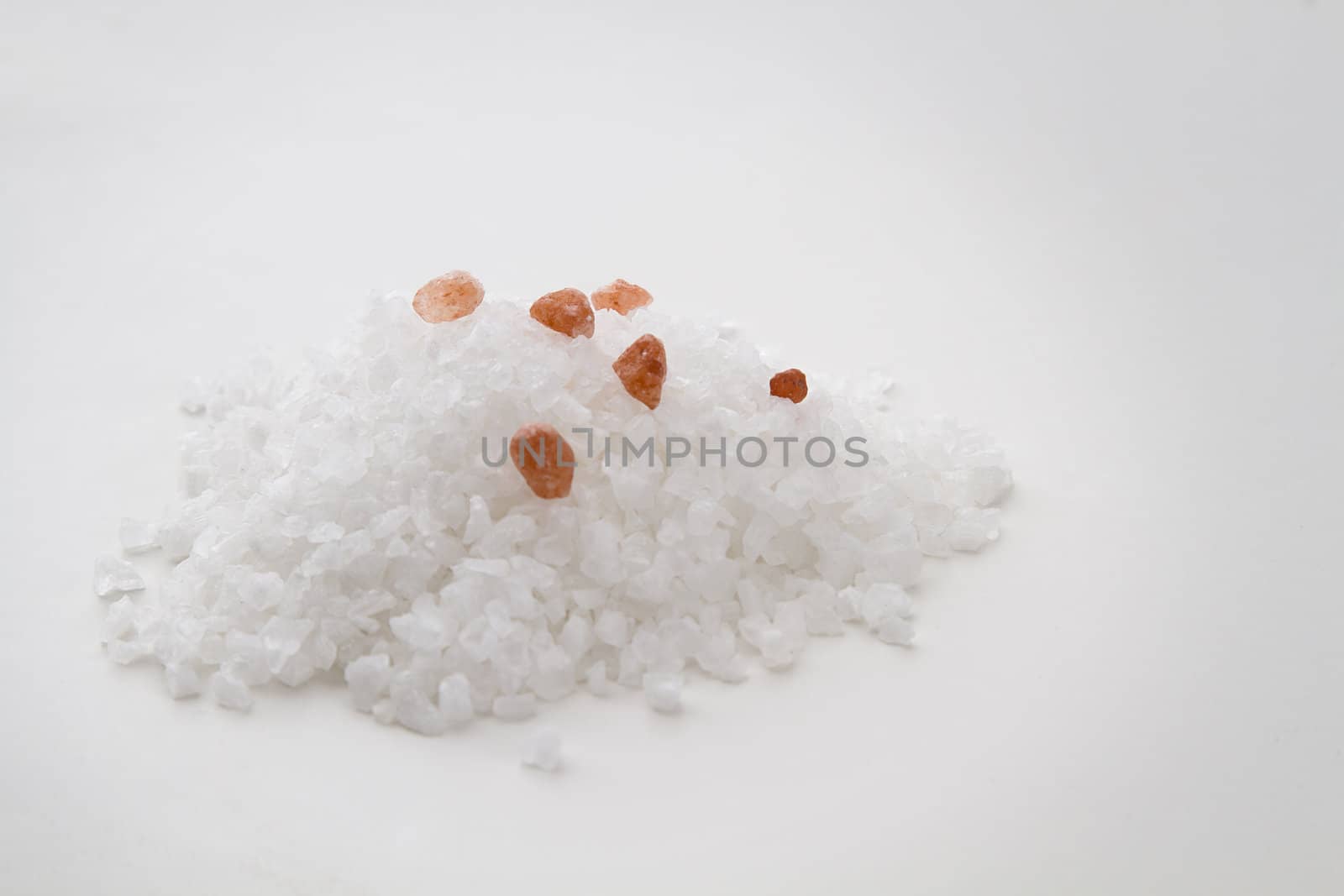 Pile of white salt crystal with 6 pink salt crystal