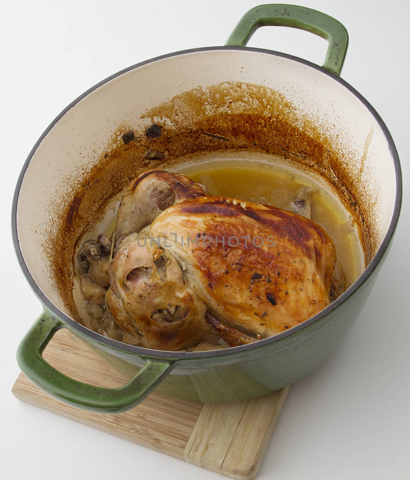 roasted chicken sitting in a cooking pot