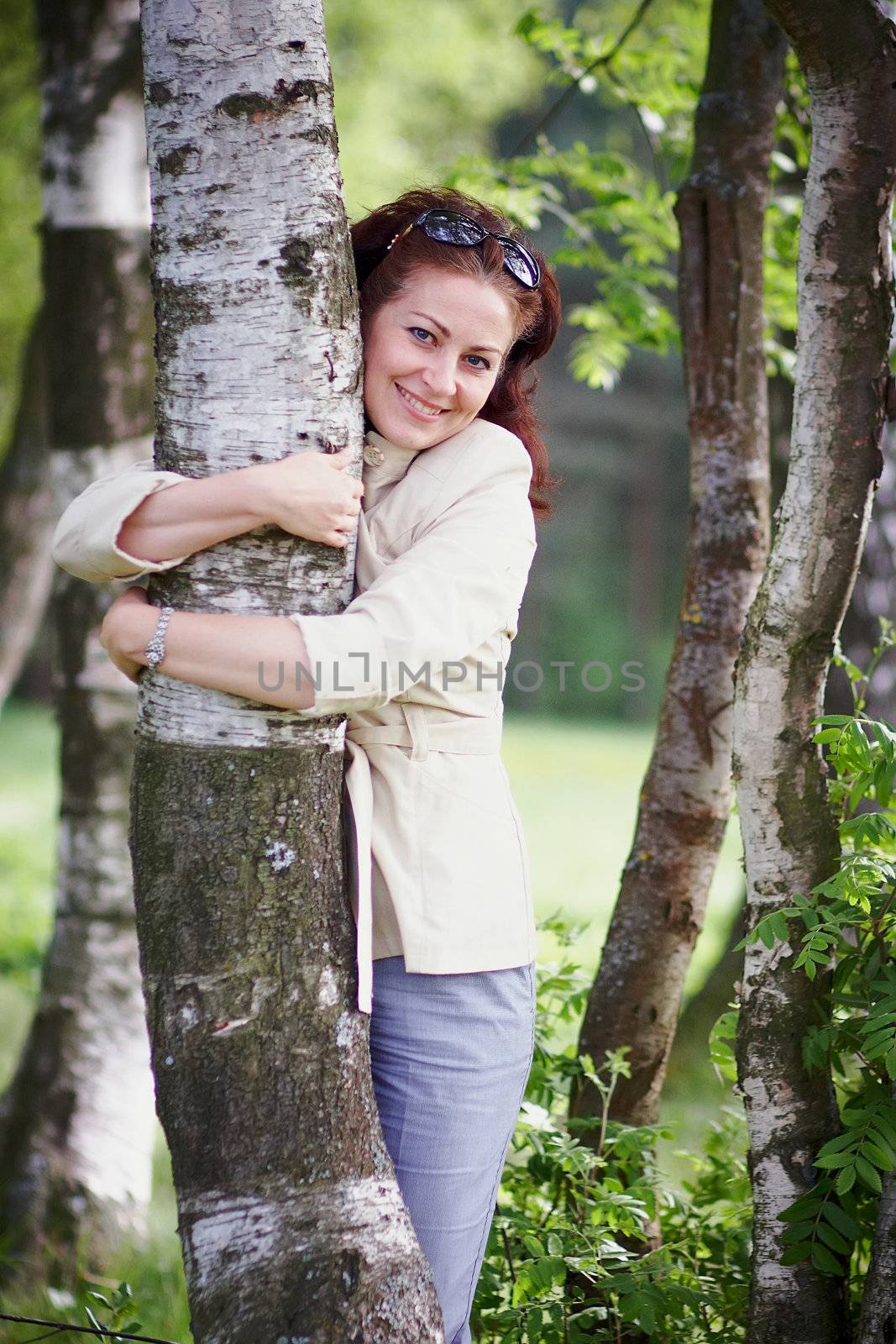 The beautiful woman embracing a birch