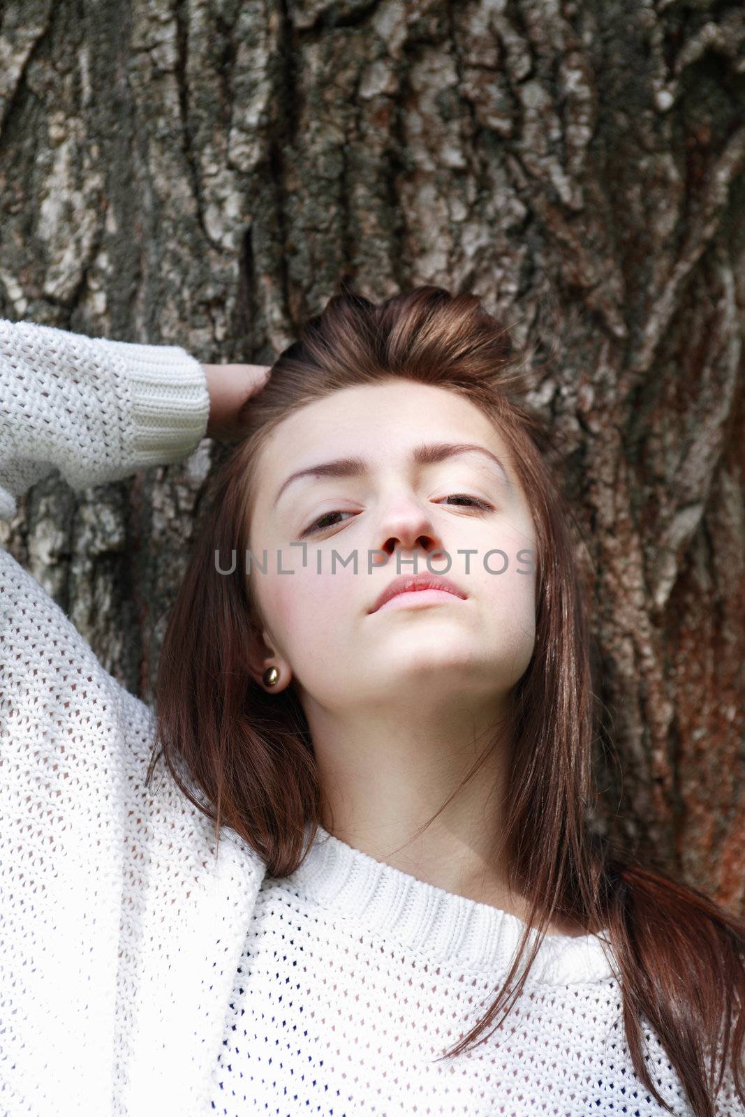 Portrait of beauty teenage girl on tree bark background