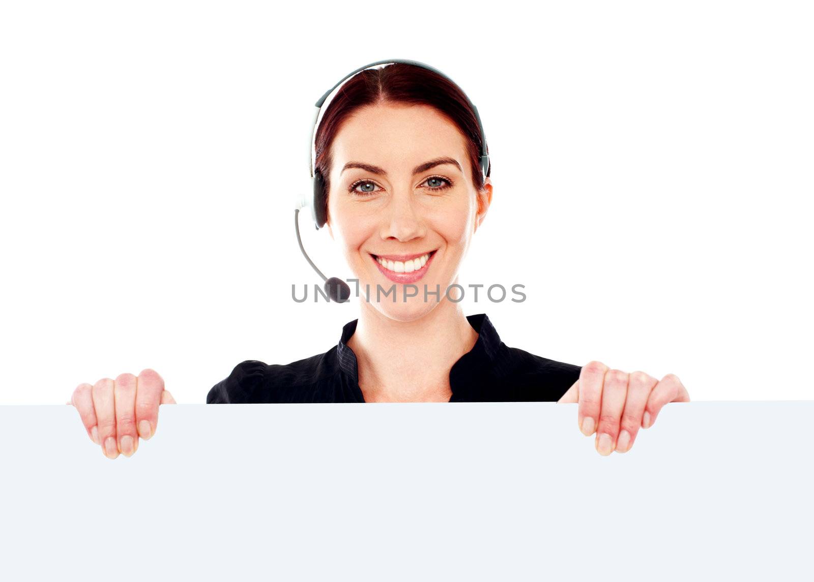 Attractive help-desk female holding blank placard. Standing right behind it