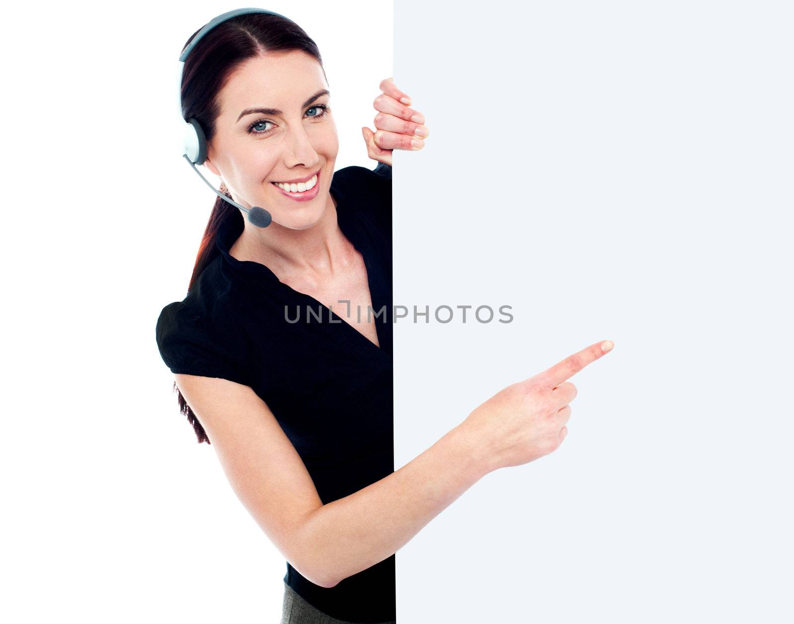Customer service woman with headset showing and pointing at blank billboard sign banner