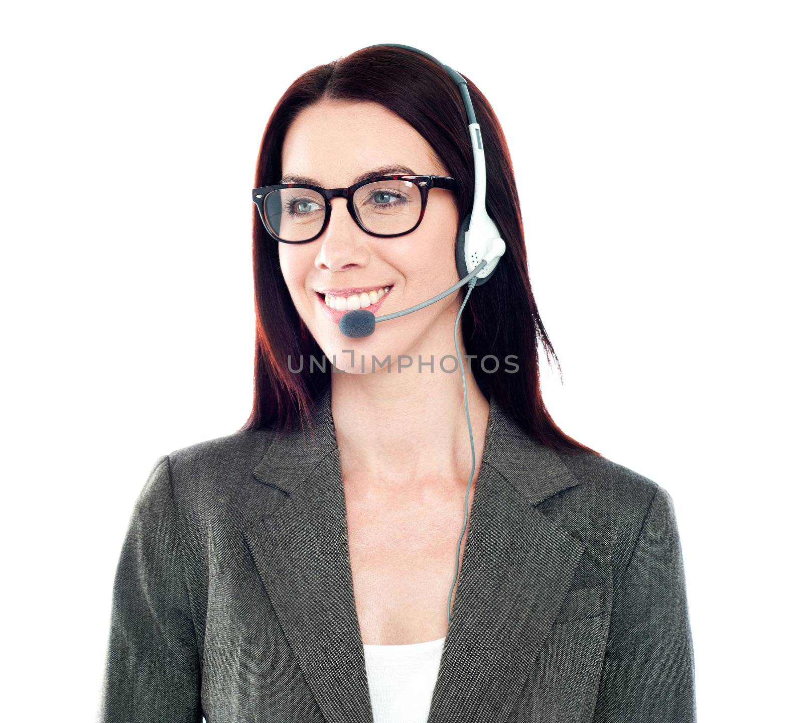 Cheerful female customer care operator looking away by stockyimages