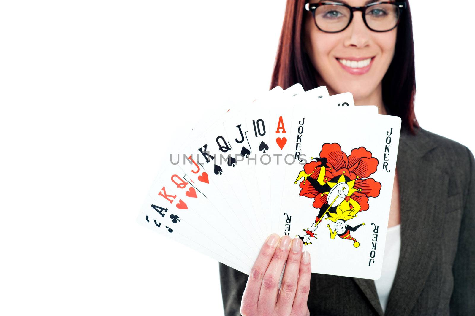 Charming businesswoman holding playing cards wearing glasses