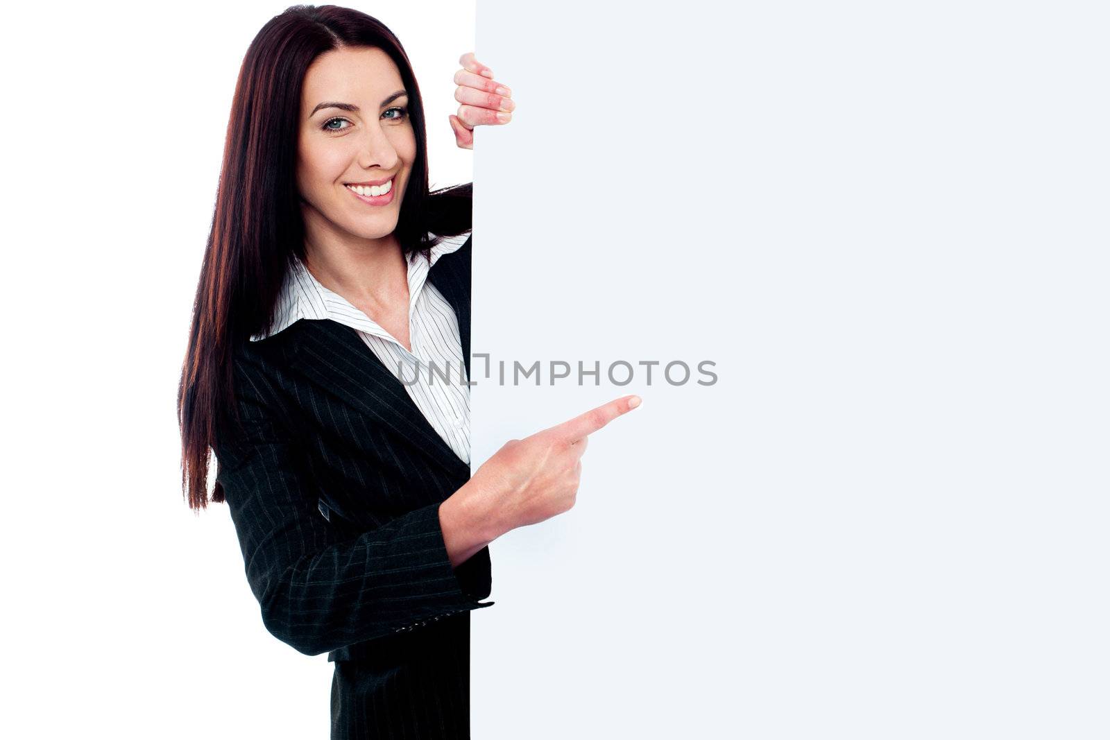 Female representative pointing towards placard, smiling at camera