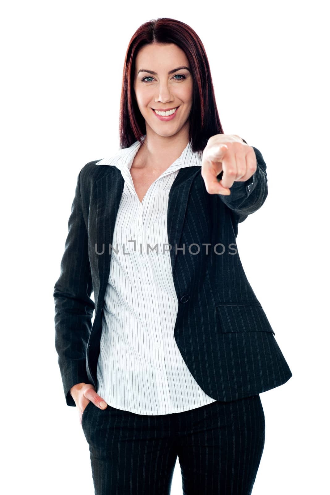 Smiling corporate lady pointing at you against white background