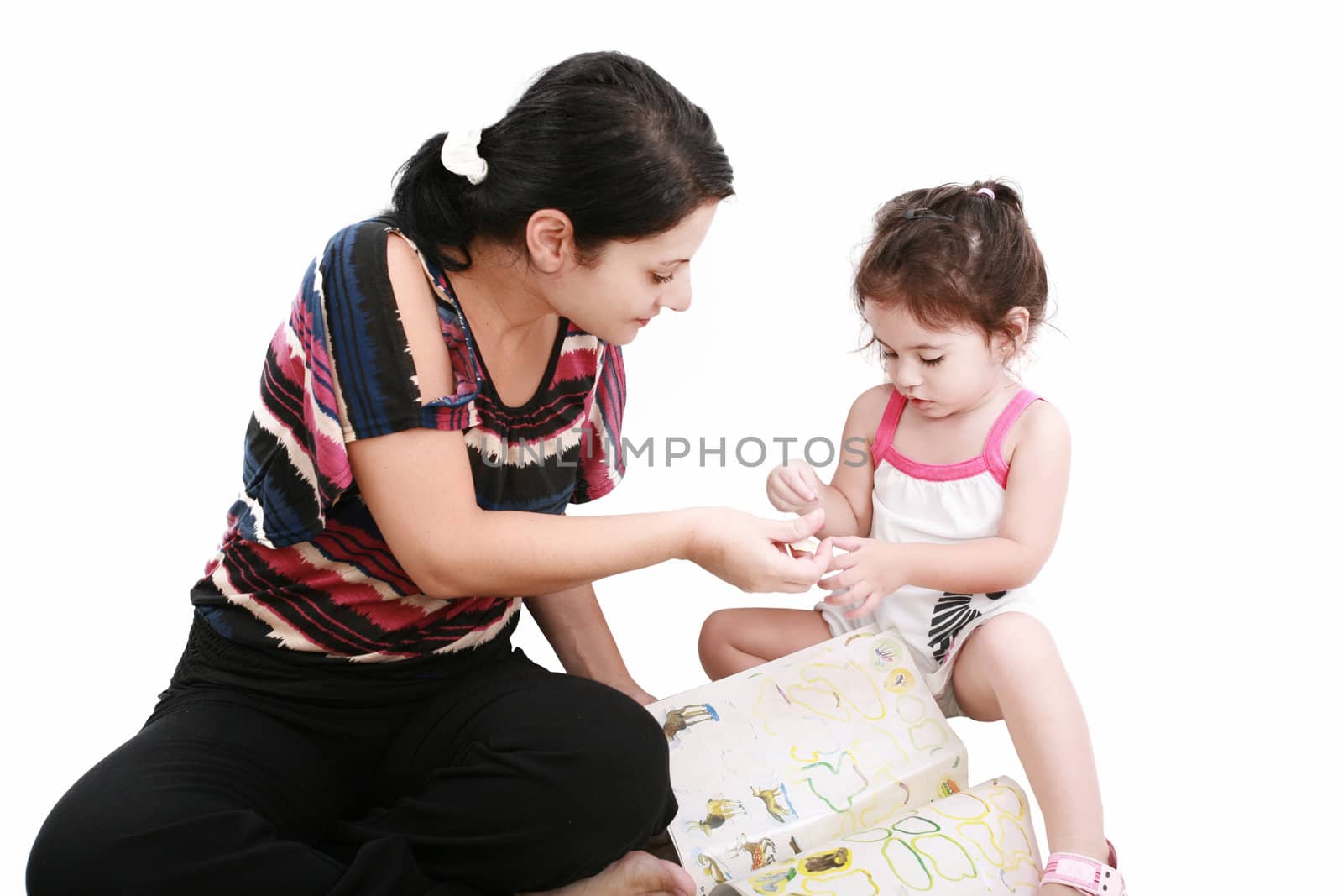 Beautiful little girl playing with her mother on the floor