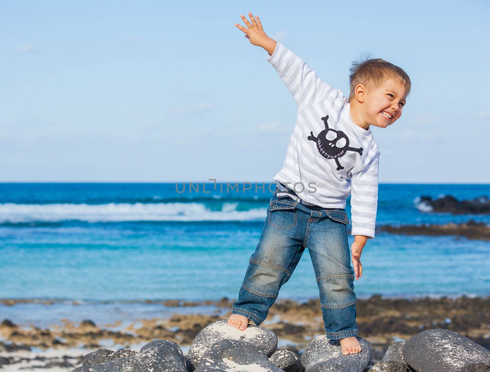 Cute boy dressed as pirate on tropical beach