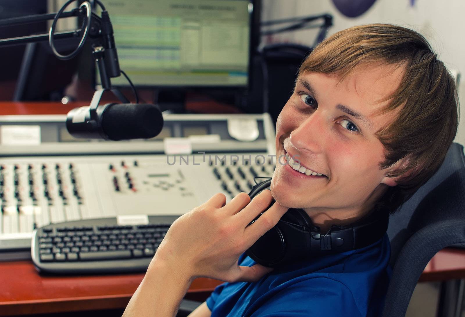 Dj in front of a microphone on the radio