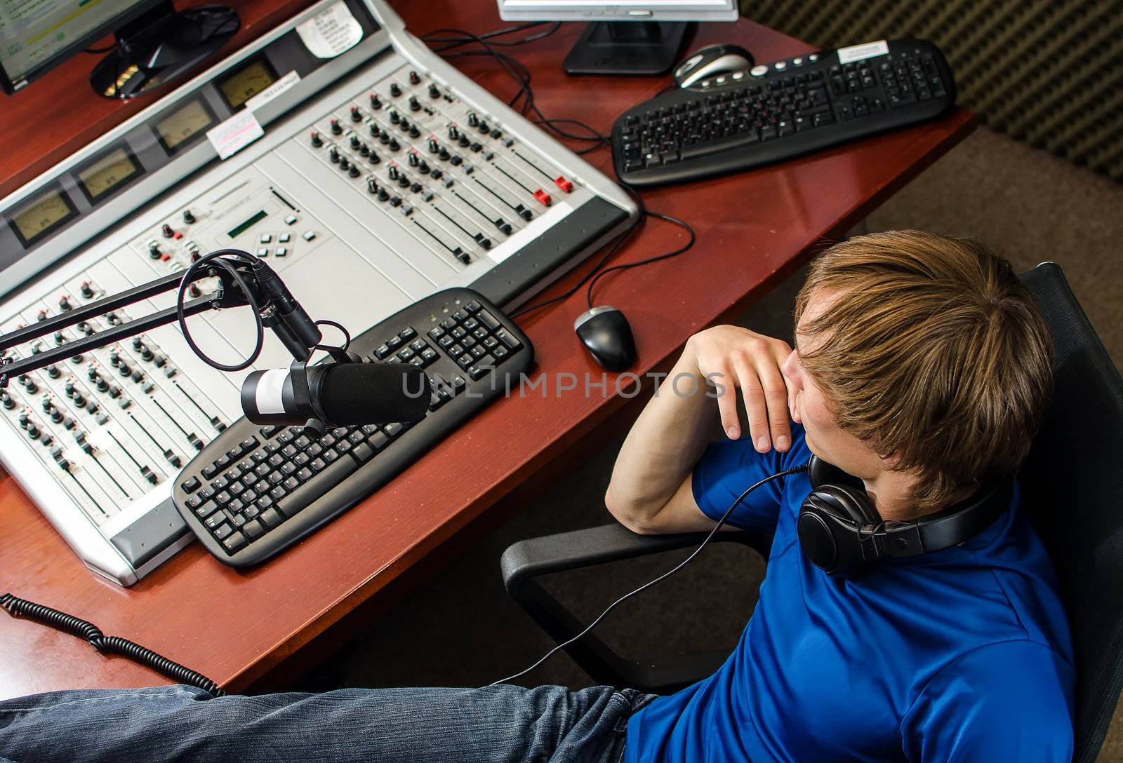 Dj working in front of a microphone on the radio, from the top