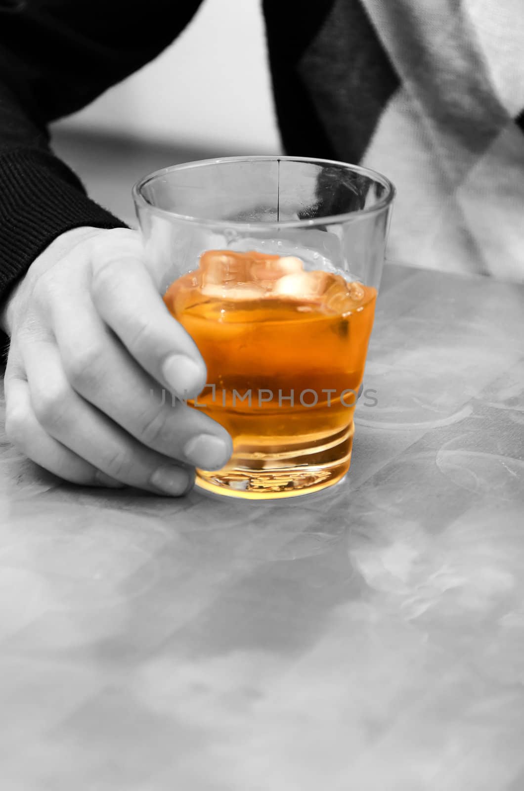 Alcohol - evil! Man's hand holding a glass of whiskey