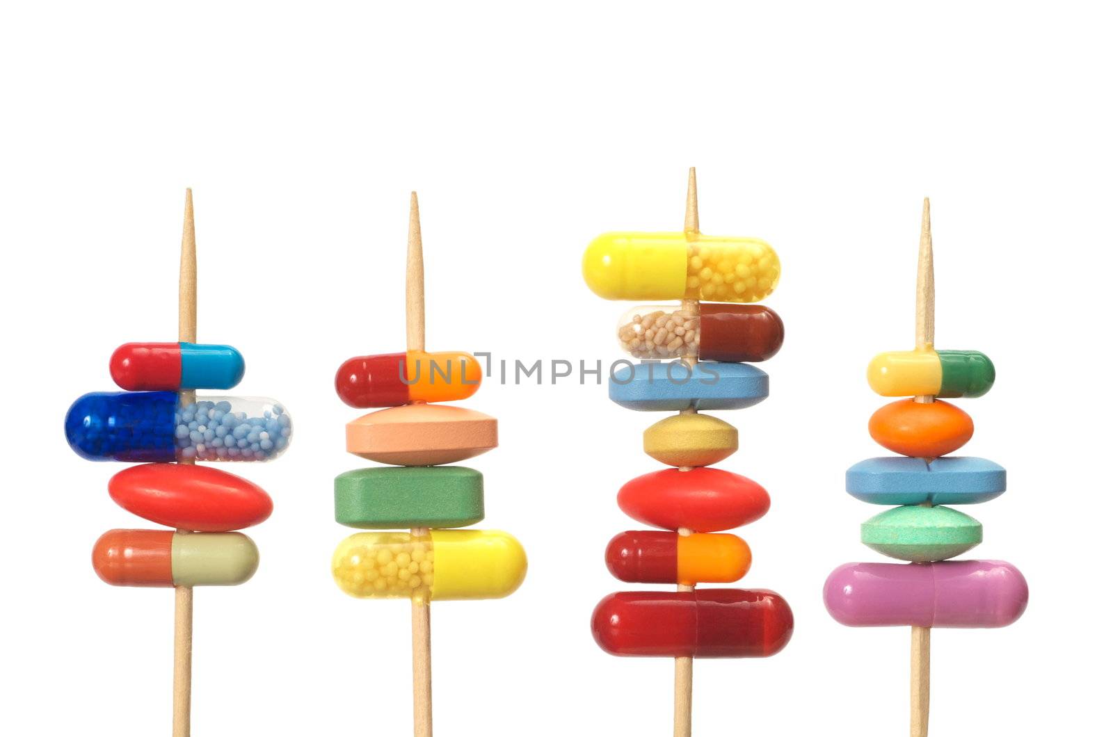 Pills on toothpicks isolated on white background