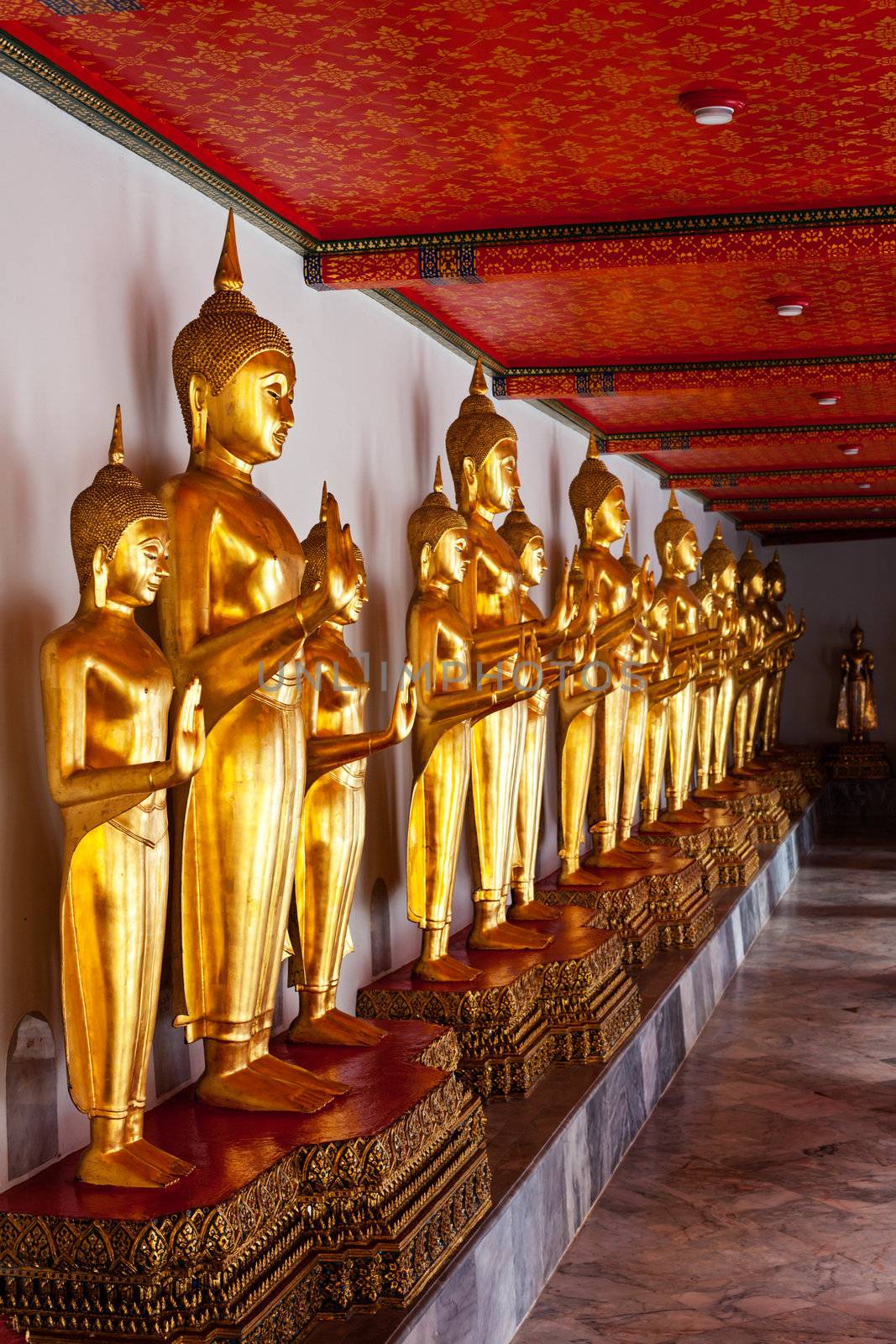 Standing golden Buddha statues. Wat Pho temple, Bangkok, Thailand