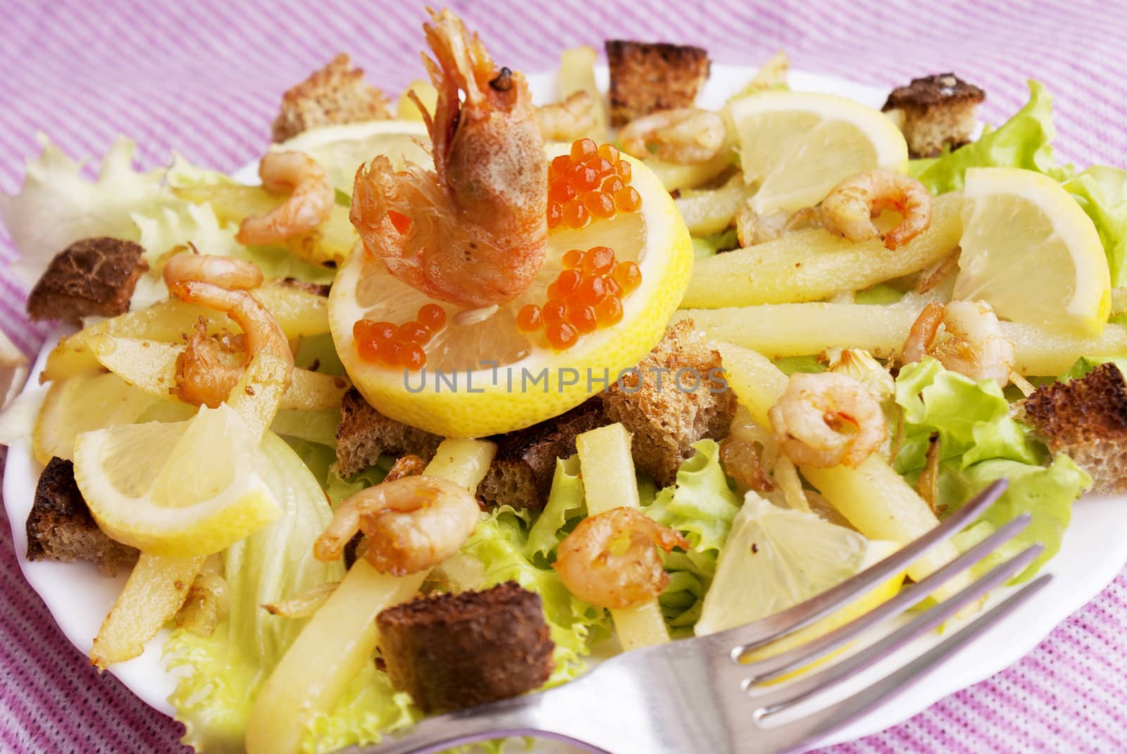 Creative fresh salad from seafood and fresh vegetables